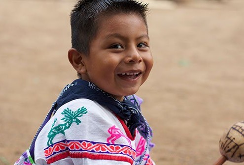 Huichol Indian Boy with Rattle. Learning shamanic traditions from childhood.